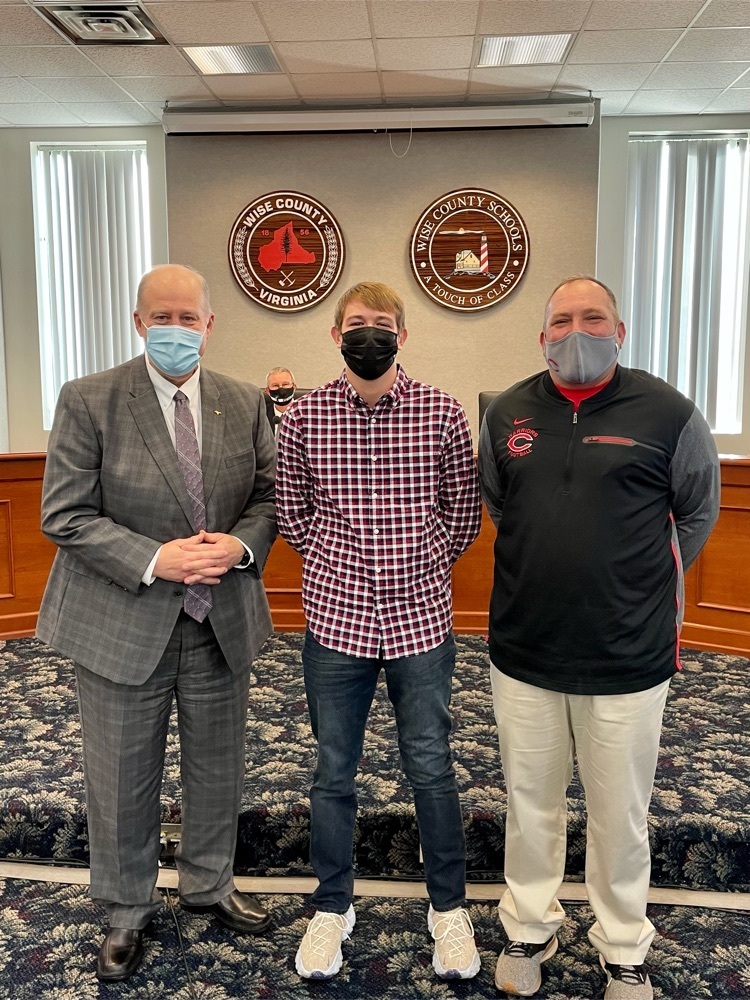 image of Maddox Reynolds with the superintendent and track coach